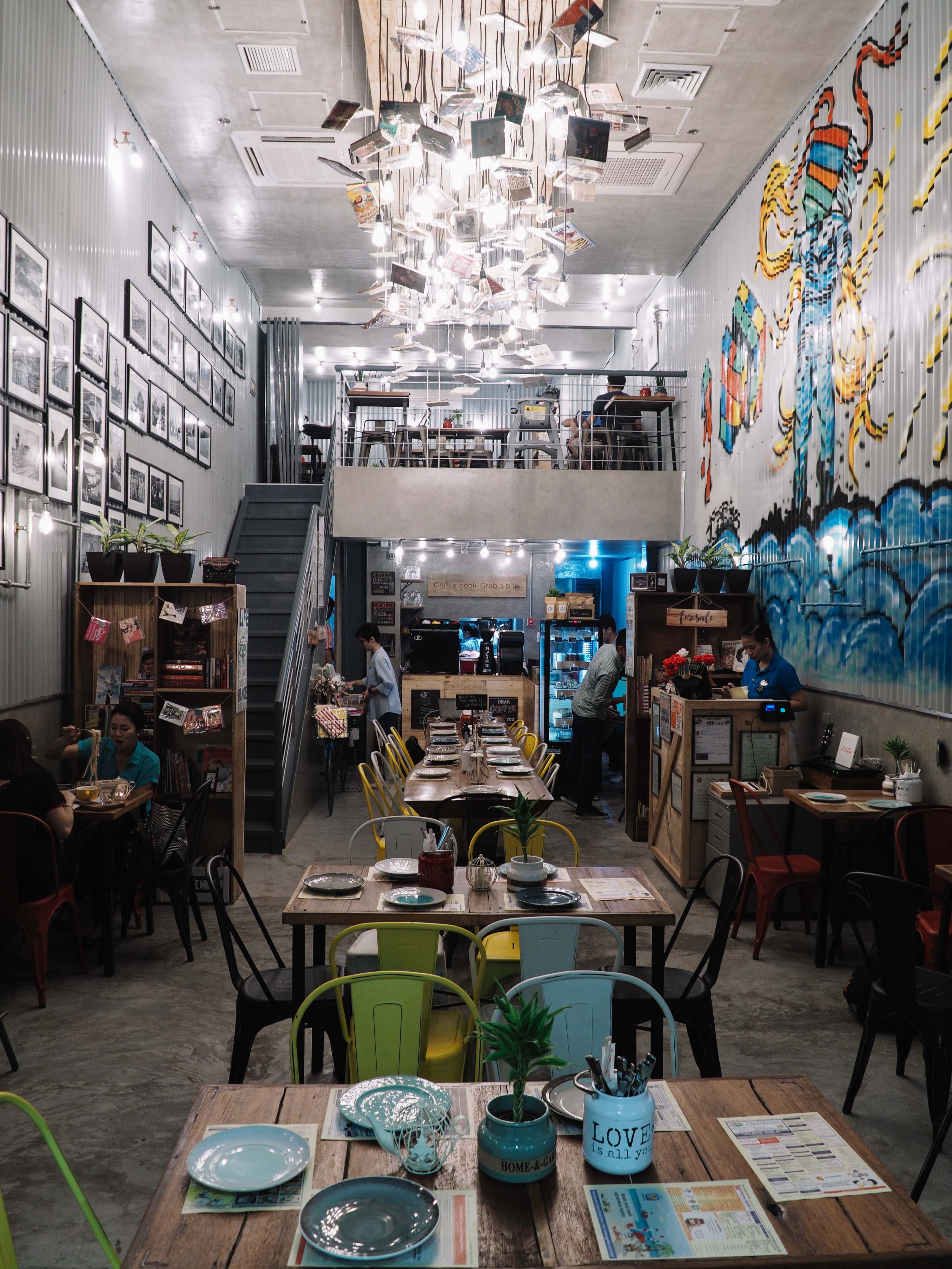 Buku-Buku Kafe’s walls are similar to that of a trailer truck with graffiti and photographs hung on them.