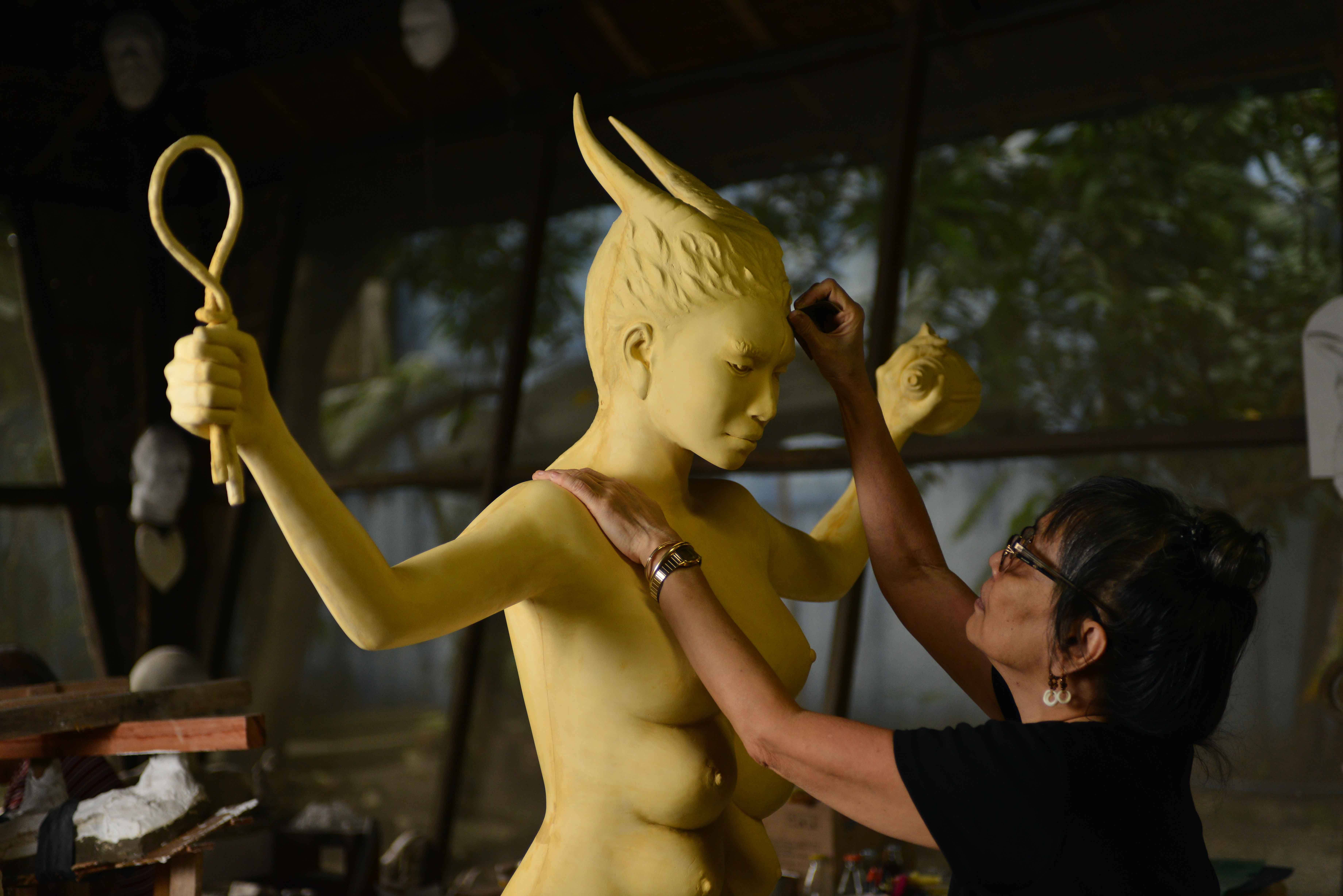 Agnes Arellano working on her Goddesses piece. Photo from Art Fair Philippines.