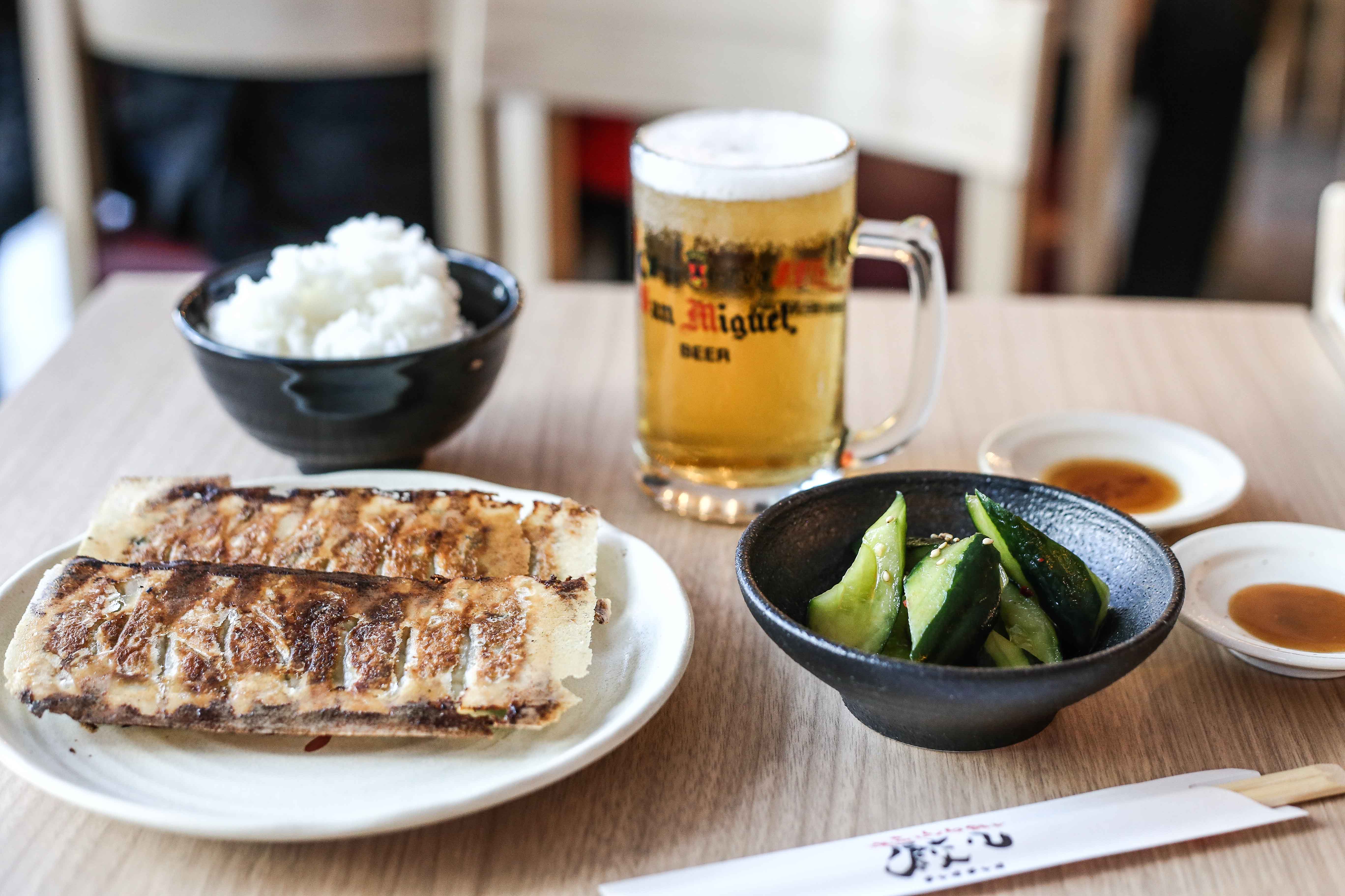 The Chao Chao Gyoza set comes with rice, a glass of beer, and your choice of sides.