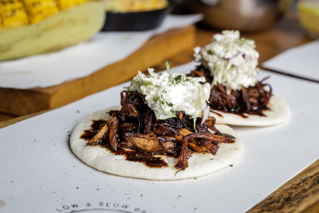 Pulled pork, served on house-made flat pan de sal.