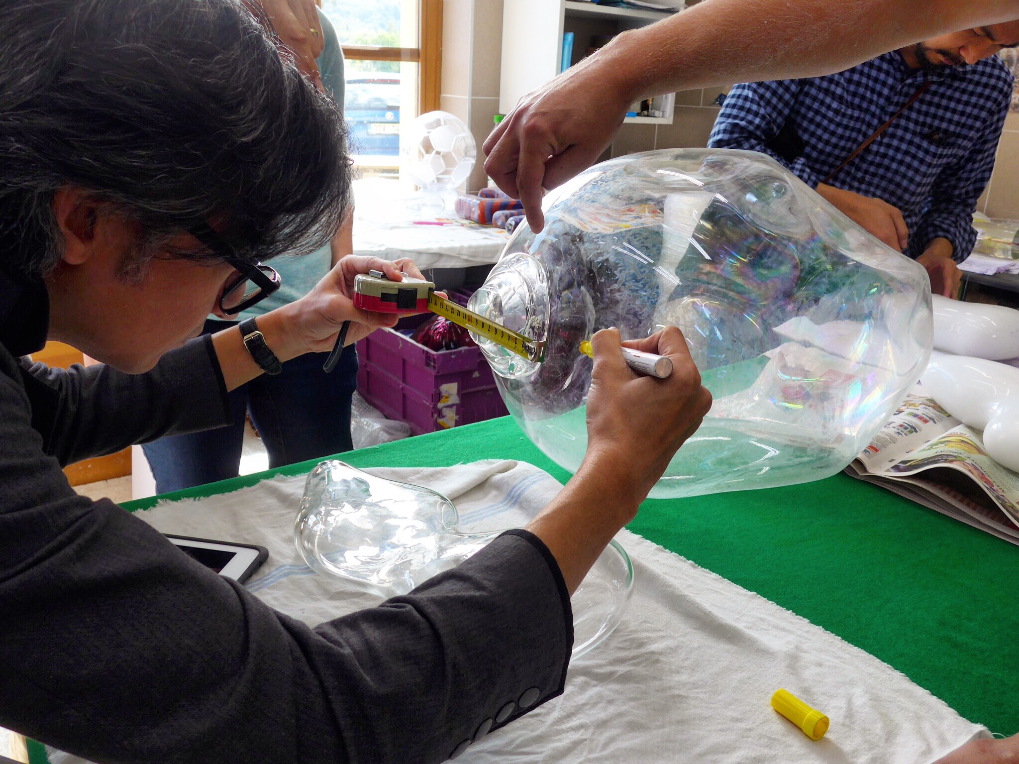 Spektacularis designers working at the glass studio in Prague. Pictured is a piece of blown glass.