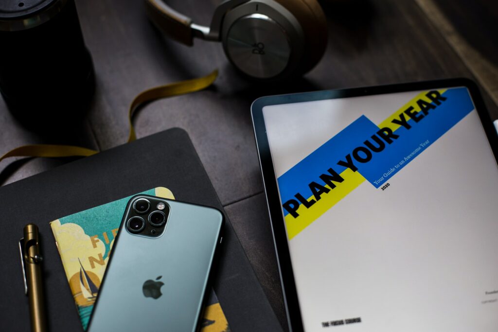 desk with new years resolution essentials planner phone