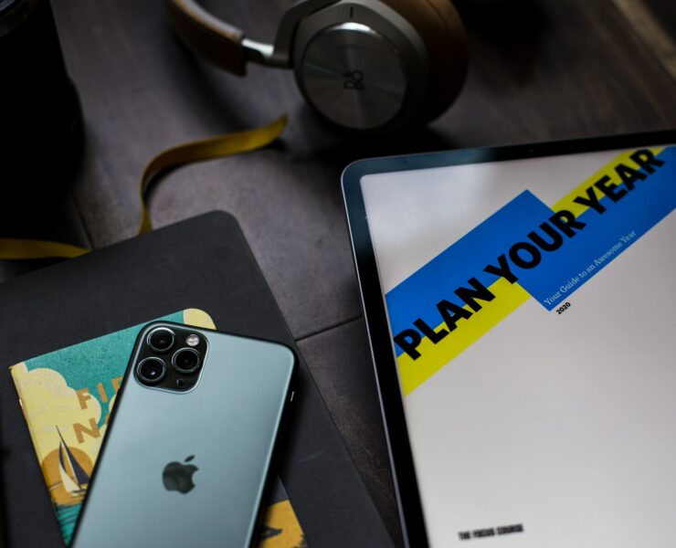 desk with new years resolution essentials planner phone