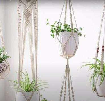 A photo of white macrame hanging planters with potted plant inside courtesy of Tatiana Cm on YouTube
