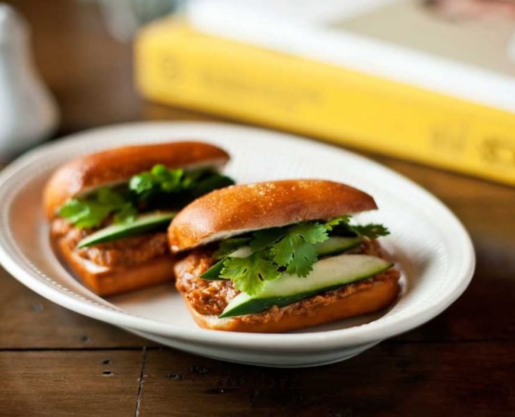 Two fried mantou buns stuffed with chili crab, cilantro, and cucumber from Your Local