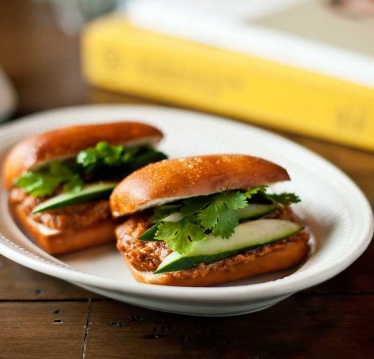 Two fried mantou buns stuffed with chili crab, cilantro, and cucumber from Your Local