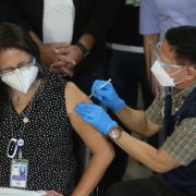 a woman injected covid-19 vaccine by a man