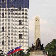 Torre de Manila looms over the Rizal Monument. Photo by Marianne Bermudez of Inquirer