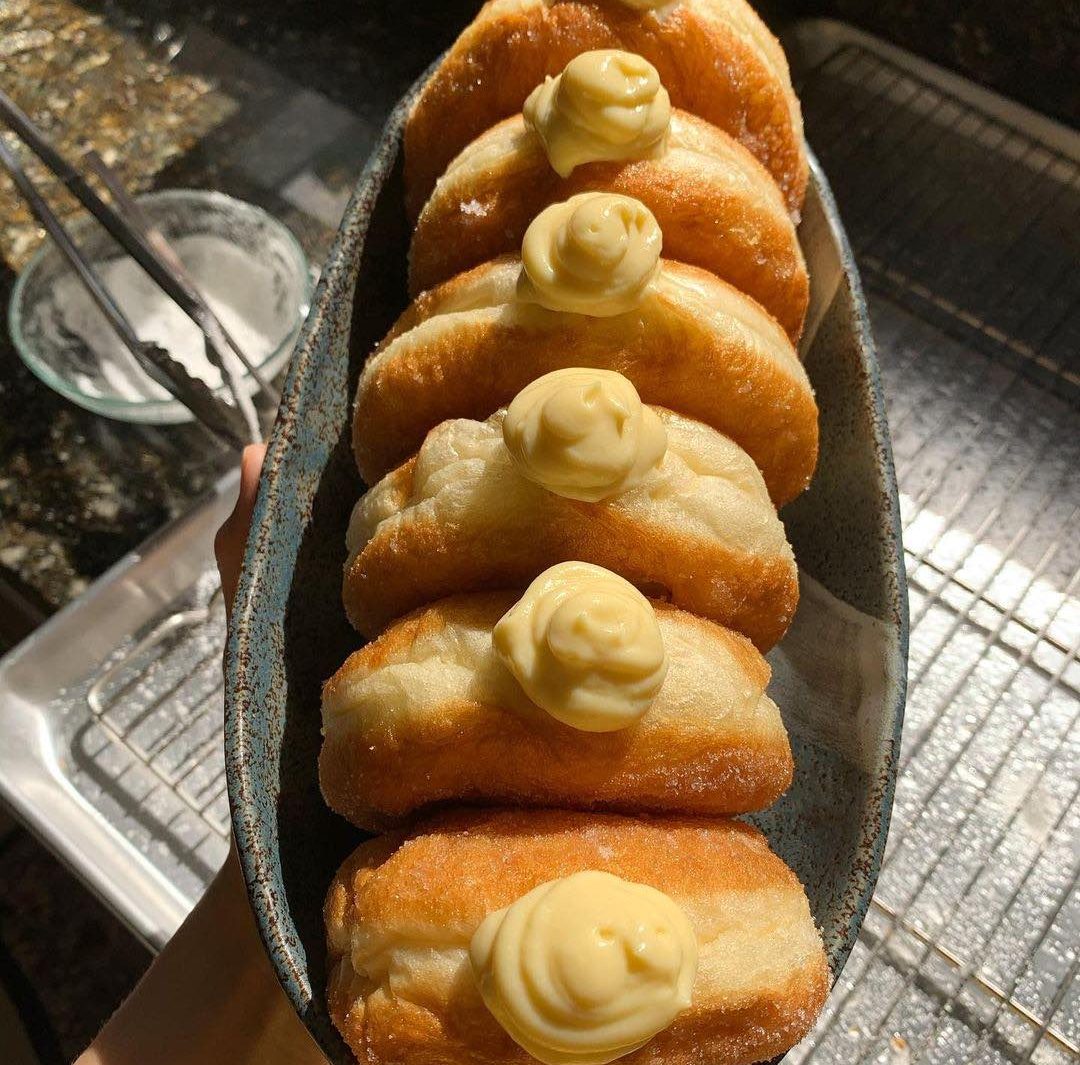 Vanilla custard donuts in a boat shaped bowl