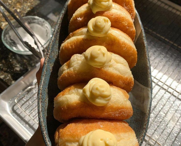 Vanilla custard donuts in a boat shaped bowl