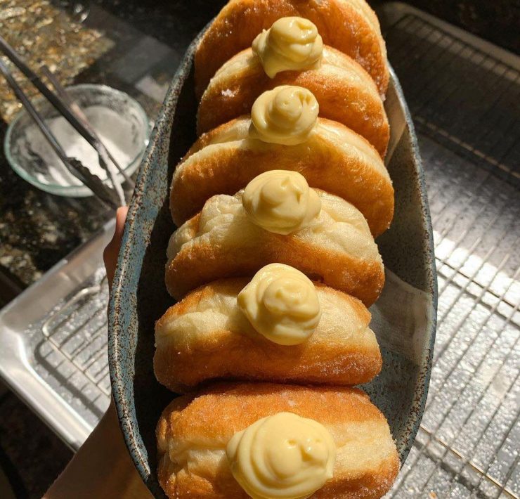 Vanilla custard donuts in a boat shaped bowl