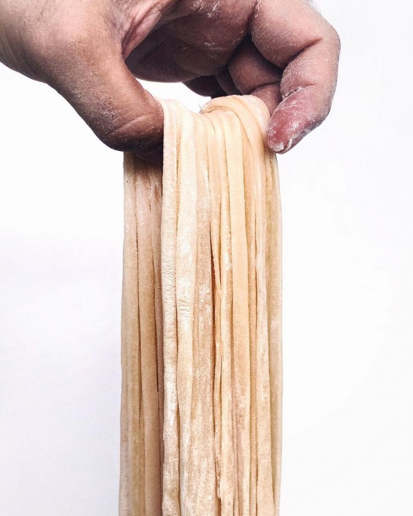 hand holding pasta strands