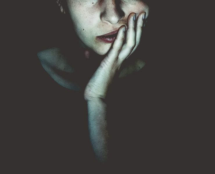 woman staring into the screen in the dark