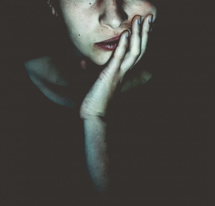 woman staring into the screen in the dark