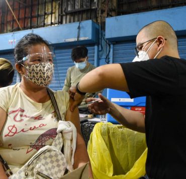 woman vaccinated for covid-19 at night in manila city
