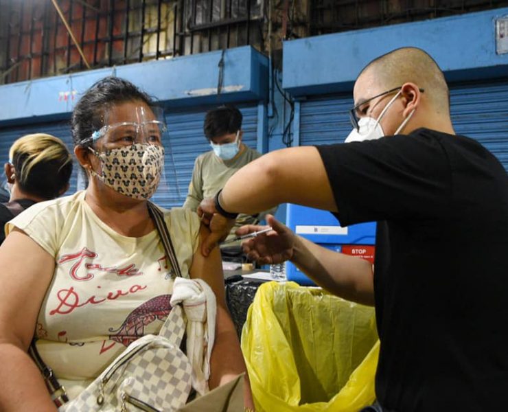 woman vaccinated for covid-19 at night in manila city