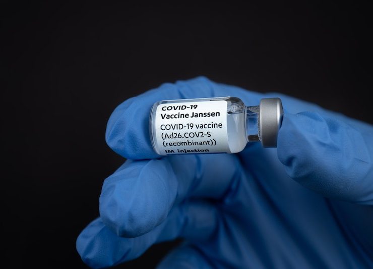 johnson&johnson janssen covid-19 vaccine vial held by a gloved hand