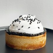 tart dessert with a mallow topping and black sesame seeeds sprinkle