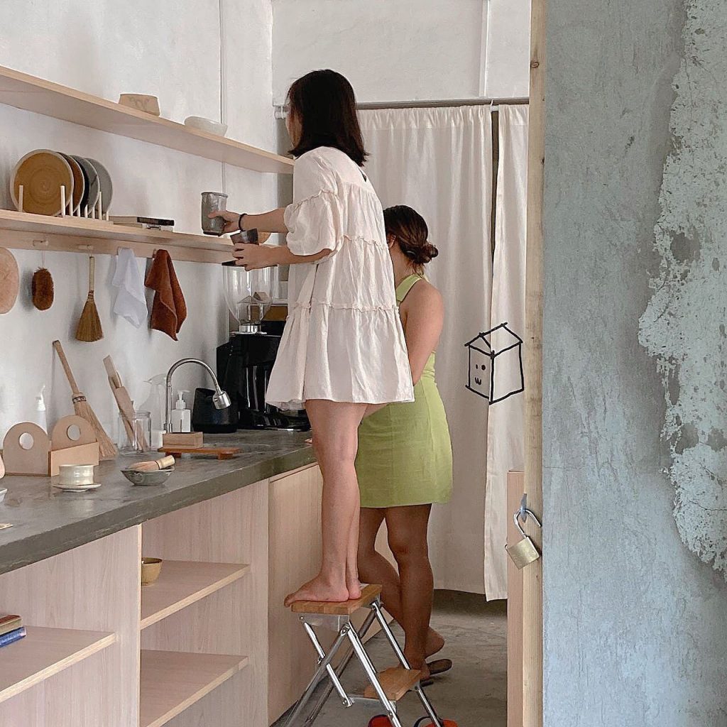 two women arranging the shelves