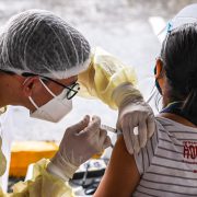 a medical worker injects a woman with covid-19 vaccine in novaliches quezon city