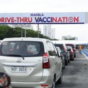 cars queuing at manila’s drive thru vaccination site