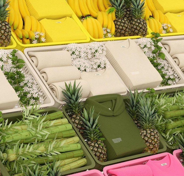 green, cream, and yellow clothes on a fruit stand with pineapples, banana and bamboo