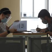 woman and man filling out forms in a government office
