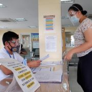woman registers to vote in person at a government office