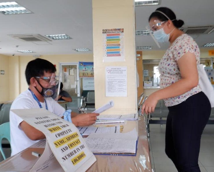 woman registers to vote in person at a government office