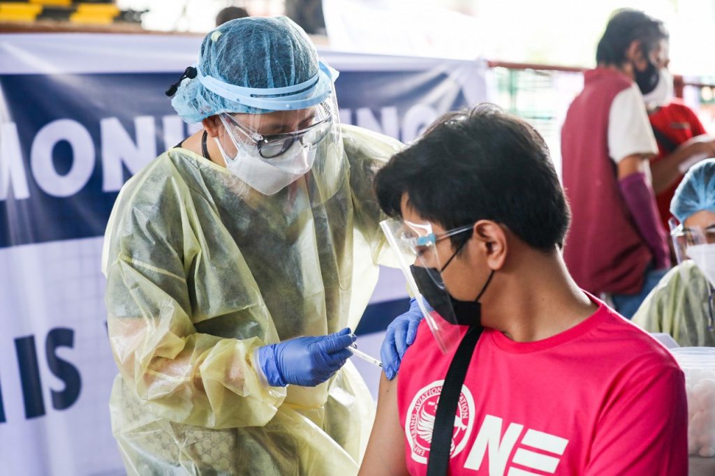 a health worker vaccinates civilian in san pedro, laguna by an initiative of the office of the vice president