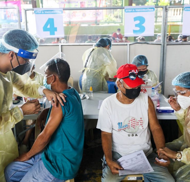 two men being vaccinated in san pedro, laguna by an initiative of the office of the vice president
