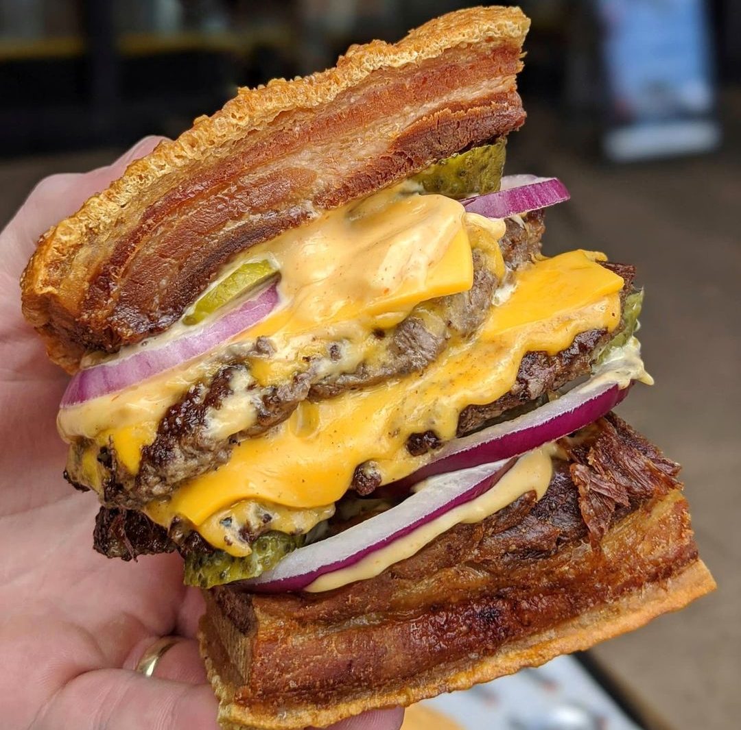 burger with lechon as buns, double patties, double cheese, pickles, rice