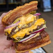 burger with lechon as buns, double patties, double cheese, pickles, rice