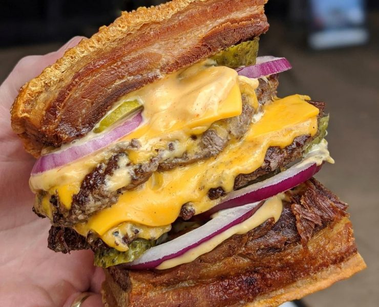 burger with lechon as buns, double patties, double cheese, pickles, rice