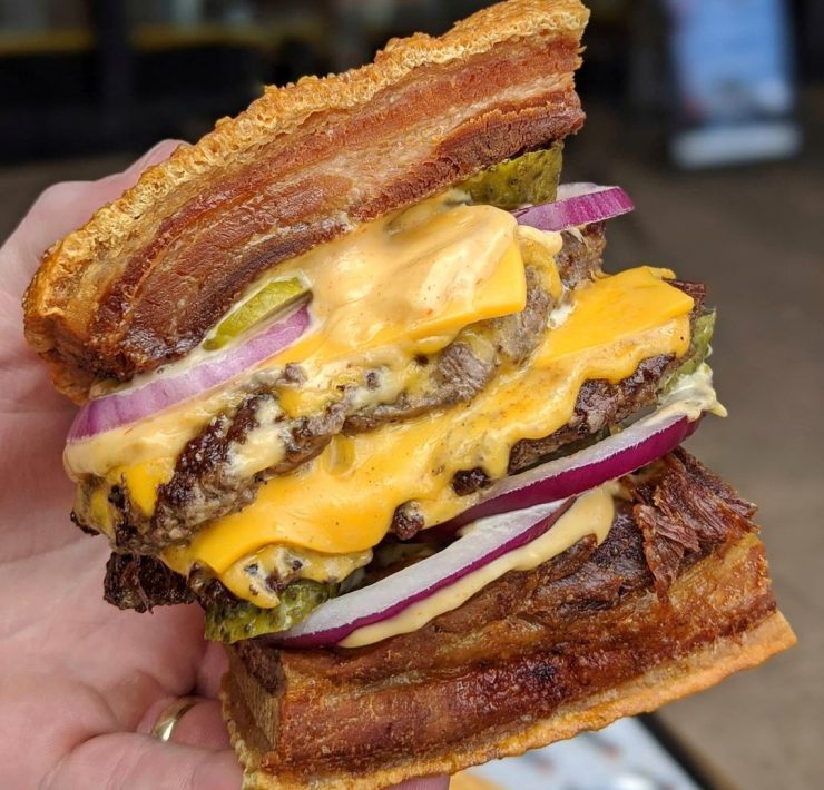 burger with lechon as buns, double patties, double cheese, pickles, rice