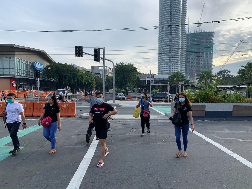pedestrians crossing an intersection in pasig city