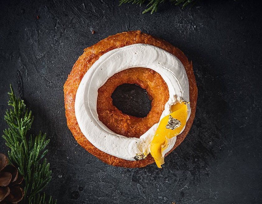 holed doughnut with icing and candied lemon