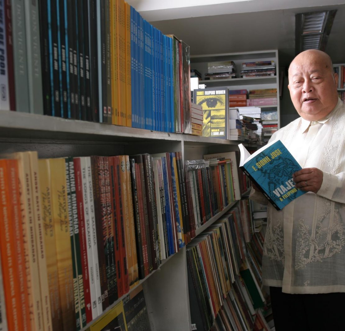 f sionil jose holding his book inside a library