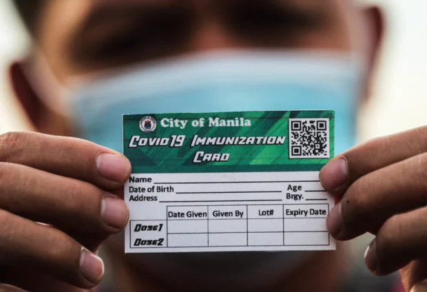 hand holding vaccination card