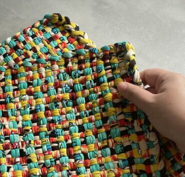 a hand holding a woven basahan mat