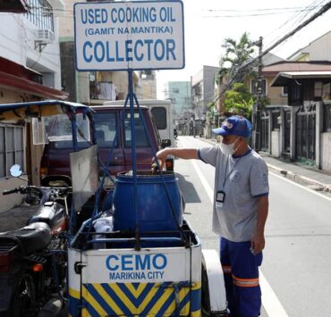employee of marikina cemo empties a bottle of used oil into a barrel for collection