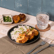 galunggong kalabasa patties on a plate with rice served with a glass of water