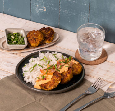 galunggong kalabasa patties on a plate with rice served with a glass of water