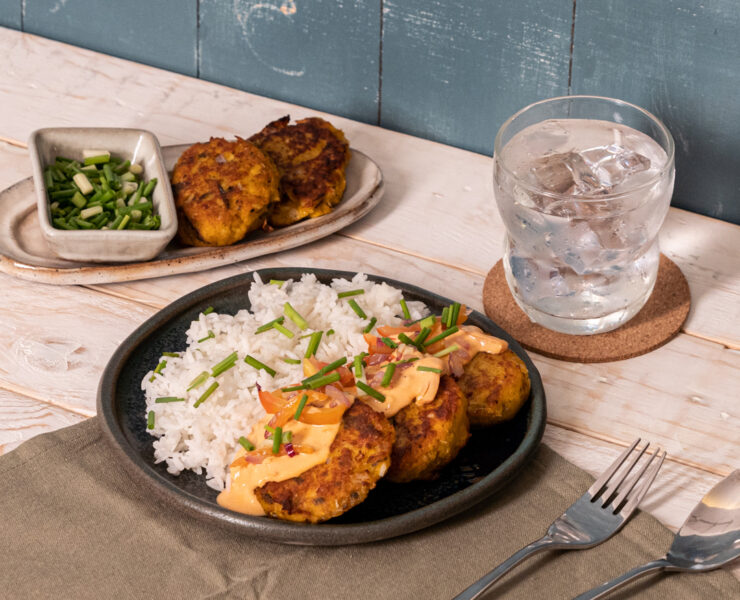 galunggong kalabasa patties on a plate with rice served with a glass of water
