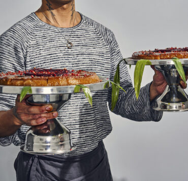 lj almendras holding two sweet rice cake with coconut caramel and chamoy